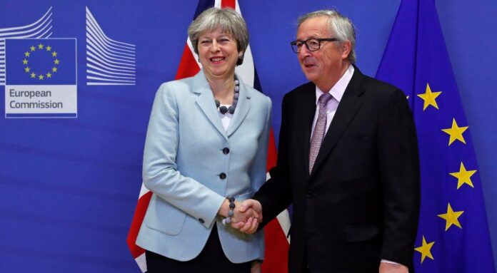 Britains Prime Minister Theresa May is welcomed by European Commission President Jean-Claude Junck