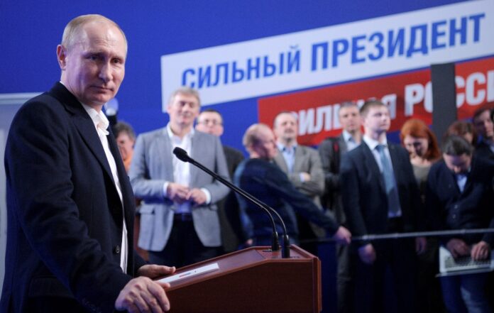 Russian President and Presidential candidate Vladimir Putin attends a news conference at his campaign headquarters in Moscow