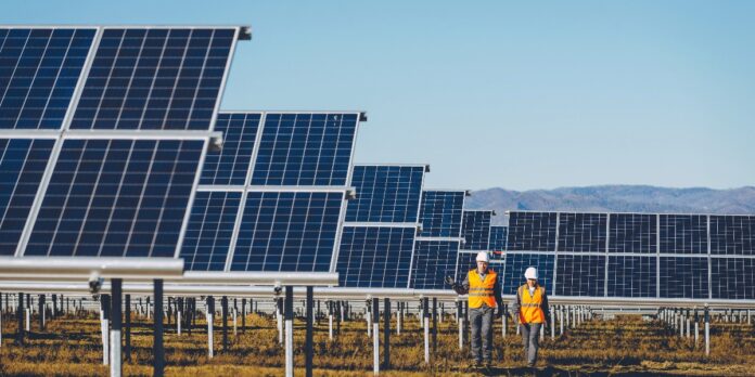 Solar power station with workers near by