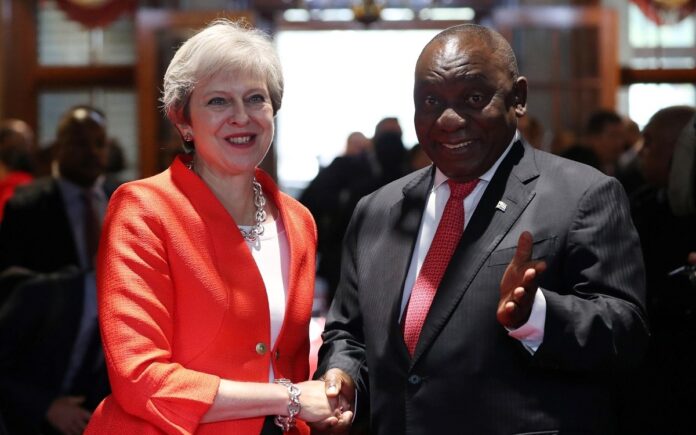 Britain's Prime Minister Theresa May is greeted by South African President Cyril Ramaphosa in Cape Town, South Africa. Image: REUTERS/Mike Hutchings