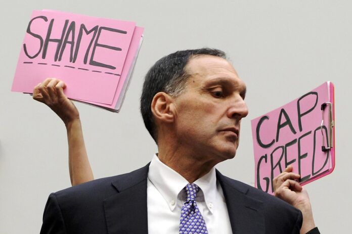 Protesters hold signs behind Richard Fuld, chairman and chief executive of Lehman Brothers Holdings. Image: REUTERS/Jonathan Ernst