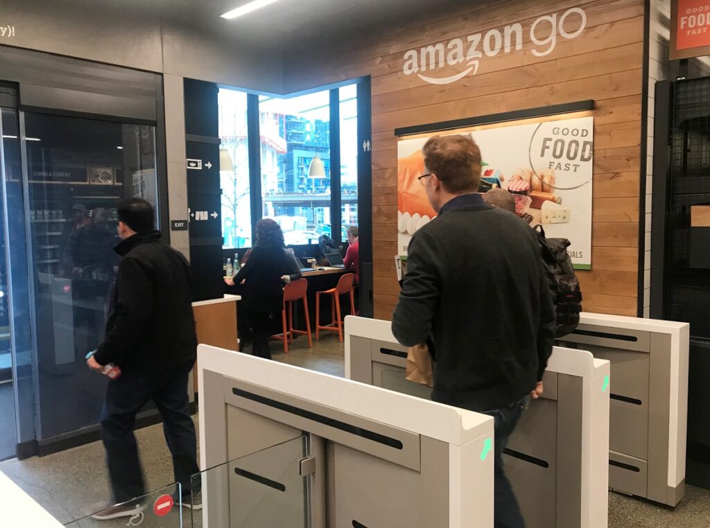 A customer walks out of the Amazon Go store, without needing to pay at a cash register due to cameras, sensors and other technology that track goods that shoppers remove from shelves and bill them automatically after they leave. (image: REUTERS/Jeffrey Dastin)