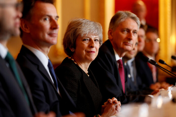 Britain's Prime Minister Theresa May sits with members of her cabinet